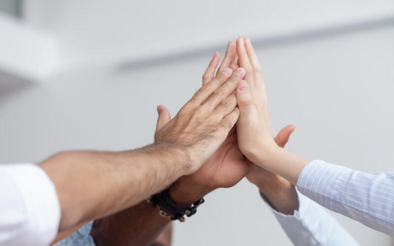 Hands cheering on light background