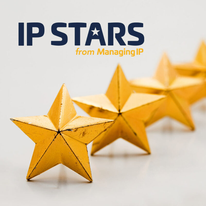 Gold stars on light grey background and IP Stars-logo